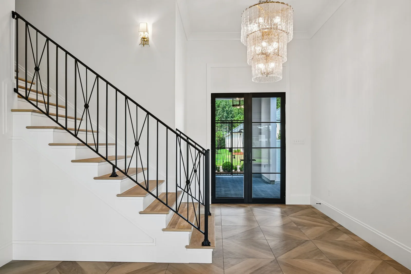 Entry, stair rail + chandelier